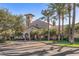 Beautiful clubhouse featuring an American flag, well-maintained landscaping, and mature trees at 26880 W Sierra Pinta Dr, Buckeye, AZ 85396