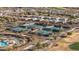 Aerial view of the community pool, tennis courts, and surrounding homes in a well-maintained neighborhood at 26880 W Sierra Pinta Dr, Buckeye, AZ 85396