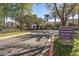 Well-manicured community entrance with landscaping, mature trees, and signage to various amenities at 26880 W Sierra Pinta Dr, Buckeye, AZ 85396
