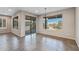 Bright dining room featuring tile flooring, large windows and sliding doors, and modern lighting fixture at 26880 W Sierra Pinta Dr, Buckeye, AZ 85396