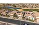 An aerial view of houses with solar panels and a well-maintained front yard with desert landscaping at 26880 W Sierra Pinta Dr, Buckeye, AZ 85396