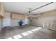 Spacious garage with overhead storage, utility connections, and room for parking and projects at 26880 W Sierra Pinta Dr, Buckeye, AZ 85396