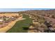 Aerial view of a lush golf course winding through a residential community against a mountain backdrop at 26880 W Sierra Pinta Dr, Buckeye, AZ 85396