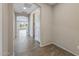 Hallway with ceramic tile floors and view to the kitchen and living room at 26880 W Sierra Pinta Dr, Buckeye, AZ 85396