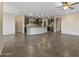 Spacious open floor plan with a kitchen featuring dark cabinets and stainless steel appliances at 26880 W Sierra Pinta Dr, Buckeye, AZ 85396