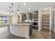 Modern kitchen featuring island with pendant lighting and ample storage in the pantry at 26880 W Sierra Pinta Dr, Buckeye, AZ 85396