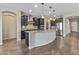 Well-appointed kitchen with island, granite countertops, and stainless-steel appliances at 26880 W Sierra Pinta Dr, Buckeye, AZ 85396