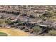 Aerial view of a well-maintained neighborhood with landscaped yards and tile roofs near a golf course at 26880 W Sierra Pinta Dr, Buckeye, AZ 85396