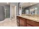 Well-lit bathroom with granite vanity, decorative window, glass enclosed shower, and modern fixtures at 31409 N 166Th Pl, Scottsdale, AZ 85262