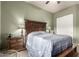 Bedroom featuring a ceiling fan, queen bed, and wood furnishings at 31409 N 166Th Pl, Scottsdale, AZ 85262