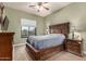 Bedroom featuring a ceiling fan, queen bed, and wood furnishings at 31409 N 166Th Pl, Scottsdale, AZ 85262