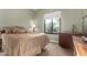 Cozy bedroom with a queen bed, plush bedding, and a view from the window at 31409 N 166Th Pl, Scottsdale, AZ 85262