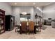 Elegant dining area with a wooden table, decorative lighting fixture, and views of the backyard at 31409 N 166Th Pl, Scottsdale, AZ 85262