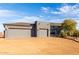 Exterior showcasing the garage and natural landscaping at 31409 N 166Th Pl, Scottsdale, AZ 85262