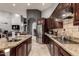Spacious kitchen featuring granite counters, stainless steel appliances, and ample dark wood cabinetry at 31409 N 166Th Pl, Scottsdale, AZ 85262