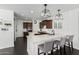 Modern kitchen with white marble countertops, dark cabinetry, pendant lighting, and stainless steel appliances at 3529 E Fandango Dr, Gilbert, AZ 85298