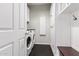 Well-lit laundry room with modern washer/dryer, storage cabinets, and an ironing board at 3529 E Fandango Dr, Gilbert, AZ 85298