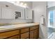 Bright bathroom with double sinks and a mirror, plus a walk-in shower at 401 E Marconi Ave, Phoenix, AZ 85022