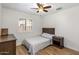 Cozy bedroom with a bed, ceiling fan, and window with shutters, offering comfort and style at 401 E Marconi Ave, Phoenix, AZ 85022