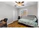 Cozy bedroom features a ceiling fan, window shutters, and a twin bed, complete with a built-in storage niche at 401 E Marconi Ave, Phoenix, AZ 85022