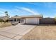 Charming single-story home with a well-maintained front yard, wide driveway, and a two-car garage at 401 E Marconi Ave, Phoenix, AZ 85022