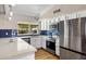 Modern kitchen with sleek stainless steel appliances, white cabinets, and stylish backsplash and countertops at 401 E Marconi Ave, Phoenix, AZ 85022