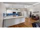 Bright kitchen with a spacious island, stainless steel appliances, and hardwood floors at 401 E Marconi Ave, Phoenix, AZ 85022