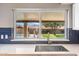 Modern kitchen sink and window showcasing the beautiful backyard and pool at 401 E Marconi Ave, Phoenix, AZ 85022