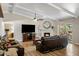 Cozy living room featuring a fireplace, ceiling fan, and sliding glass doors to the backyard at 401 E Marconi Ave, Phoenix, AZ 85022