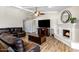 Inviting living room boasts a fireplace, a large television, and comfortable seating for relaxation and entertainment at 401 E Marconi Ave, Phoenix, AZ 85022