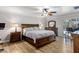 Spacious primary bedroom with a ceiling fan, hardwood floors, and a dresser at 401 E Marconi Ave, Phoenix, AZ 85022