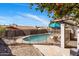 Backyard with a refreshing fenced pool, lounge chairs, fruit trees, and covered patio for outdoor enjoyment at 401 E Marconi Ave, Phoenix, AZ 85022