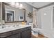 A well-lit bathroom featuring a vanity with a large mirror and a combined tub and shower at 4121 E Ashurst Dr, Phoenix, AZ 85048