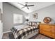 A quaint bedroom with a black metal bed frame, patterned bedding, and vaulted ceiling at 4121 E Ashurst Dr, Phoenix, AZ 85048