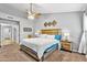 A cozy bedroom featuring a rustic wooden bed frame, soft carpeting, and neutral wall colors at 4121 E Ashurst Dr, Phoenix, AZ 85048