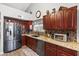 Well-equipped kitchen with stainless steel refrigerator, granite countertops, and ample cabinet space at 4121 E Ashurst Dr, Phoenix, AZ 85048