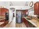 Updated kitchen featuring granite countertops, stainless steel appliances, and rich wood cabinetry at 4121 E Ashurst Dr, Phoenix, AZ 85048