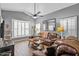 Comfortable living room with wood-look tile floors, a ceiling fan, and a large window with shutters at 4121 E Ashurst Dr, Phoenix, AZ 85048