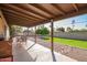 Enjoy the expansive covered patio overlooking the landscaped backyard with a BBQ and dining furniture at 5123 E Beck Ln, Scottsdale, AZ 85254