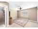 Cozy bedroom with neutral tones, a ceiling fan, and an en-suite bathroom at 5123 E Beck Ln, Scottsdale, AZ 85254