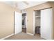 Cozy bedroom with neutral carpet, a white door, and a closet space with sliding doors at 5123 E Beck Ln, Scottsdale, AZ 85254