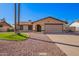 Charming single-story home featuring desert landscaping, a two-car garage and neutral toned exterior paint at 5123 E Beck Ln, Scottsdale, AZ 85254