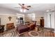 Comfortable living room featuring a ceiling fan and an inviting leather armchair with an ottoman at 5123 E Beck Ln, Scottsdale, AZ 85254