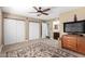 Inviting main bedroom with neutral carpet, ceiling fan, and ample closet space at 5123 E Beck Ln, Scottsdale, AZ 85254