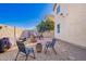 The backyard features a gravel ground cover, brick patio, and a fire pit with chairs, perfect for outdoor gatherings at 5145 W Odeum Ln, Phoenix, AZ 85043