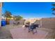 Backyard features a brick paver patio, gravel surround, and a table and chairs, perfect for relaxation and entertainment at 5145 W Odeum Ln, Phoenix, AZ 85043