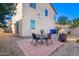 The backyard features a brick paver patio with chairs and a table, perfect for outdoor entertaining and gatherings at 5145 W Odeum Ln, Phoenix, AZ 85043