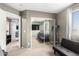 Neutral bedroom with a large window, mirrored closet, and gray futon for lounging or as a guest room at 5145 W Odeum Ln, Phoenix, AZ 85043