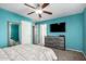 Bedroom with a ceiling fan, a dresser, a TV, neutral carpet and good lighting at 5145 W Odeum Ln, Phoenix, AZ 85043