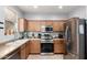 Well-equipped kitchen with modern appliances, ample counter space, and wood cabinetry at 5145 W Odeum Ln, Phoenix, AZ 85043